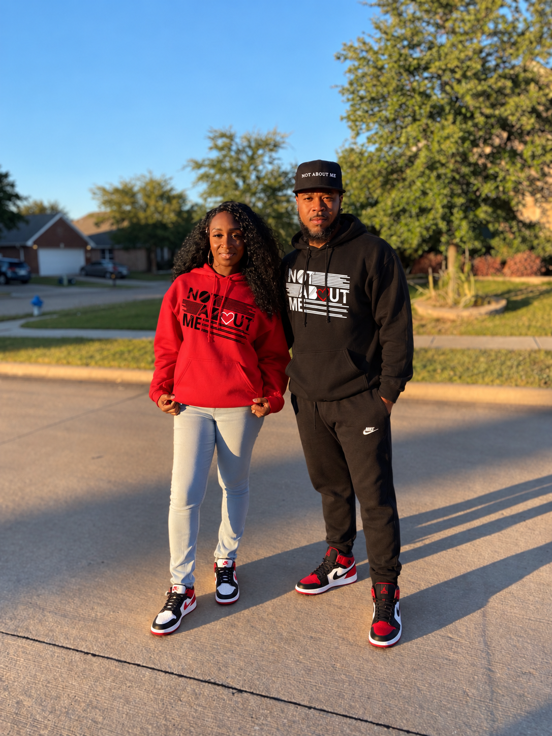 AI-assisted edit of Keedren and Keturah Boston wearing black and red Not About Me Love hoodies